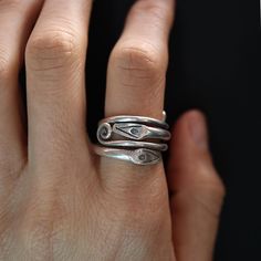 Discover the mystique of the Karen Silver Snake Wrap Ring. Handcrafted by skilled Karen artisans in Northern Thailand, this unique piece features a snake design that elegantly wraps around your finger. Made from high-quality Karen silver, renowned for its distinctive texture and craftsmanship, this ring embodies both tradition and modern style. Perfect for those who appreciate symbolic jewelry and the artistry of handmade creations. * Material: Premium 925 sterling silver, ensuring durability an Artisan Sterling Silver Ring With Unique Design, Handmade Sterling Silver Snake Ring, Handmade Symbolic Sterling Silver Snake Ring, Artistic Sterling Silver Open Ring, Handmade Sterling Silver Open Snake Ring, Unique Sterling Silver Open Snake Ring, Handmade Sterling Silver Spiral Rings, Snake Gift, Silver Snake Ring