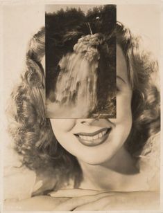 an old black and white photo of a woman's face with her hair pulled back