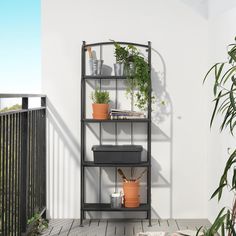 a balcony with potted plants on the shelves