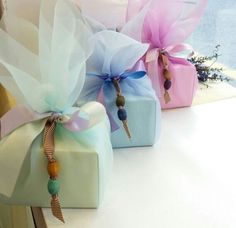 three wrapped gift boxes sitting on top of a window sill next to each other