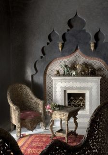 a living room filled with furniture and a fire place next to a wall mounted fireplace