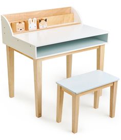 a wooden desk and bench with two toy animals