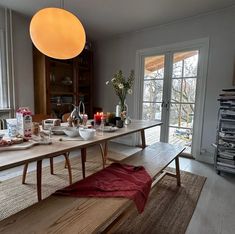 a dining room table with plates and bowls on it