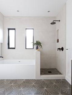 a bathroom with a bathtub, sink and toilet in it's center area