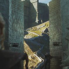 a man standing in front of an entrance to a castle