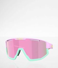 a pair of pink and green goggles sitting on top of a white countertop