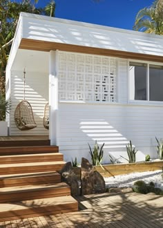 a white house with wooden steps leading up to it