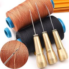 four spools of thread with needles and needle tips