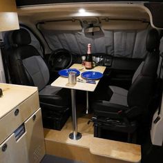 the interior of an rv with two small tables