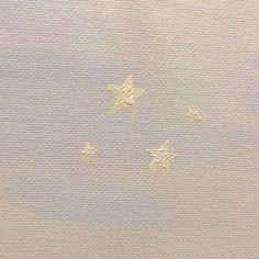 five gold stars on white paper