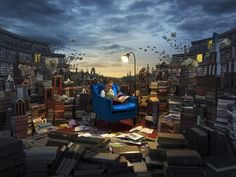 a person sitting in a blue chair surrounded by books