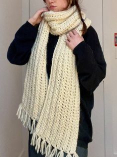 a woman wearing a white crocheted scarf