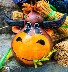 a ceramic cow head sitting next to some brooms