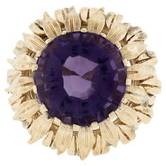 --Stone(s):-- (1) Natural Genuine Amethyst - Round Step Cut - Multi Prong Set - Medium to Dark Purple Color - 13.8mm (approx.) Material: Solid 14K Yellow Gold Weight: 13.93 Grams Ring Size: 7.0 (Fitted on a finger. We can custom size this ring. - Please let us know prior to purchase for sizing inquiries.) Ring Width: 22.8mm (0.90") (top of the ring at the halo - north to south), 4.5mm (bottom of the shank) Ring Height: 13mm rise off the finger Condition: Vintage. Shows some light wear. Excellent Flower Texture, Step Cut, Ring Vintage, Cocktail Rings, Dark Purple, Purple Color, Prong Setting, Or Rose, Halo