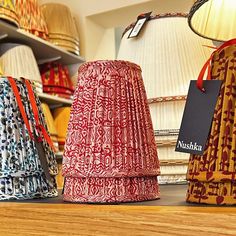 three lampshades sitting on top of a wooden table