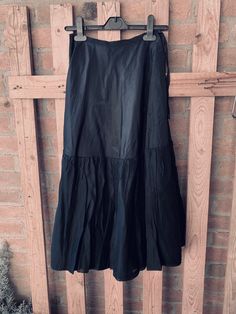 "This is an old underskirt, a petticoat, I guess from 30's, tailored and hand-stitched, black silk or satin with ruffles. In the past it was wearing under the clothes to \"puffing\", to give volume to the lower part of the clothes with very narrow waist. It can be also wear as is with texani boots for a gorgeous cow-girl style ! or with doc marten's and black leather jacket for a rockers look SO COOL SIZE unknown Approx measures : Waist line 11.82\" hips line 24.43\" hem line 43.34\" Length 30.3 Black Ruffled Full Skirt Petticoat, Black Tiered Skirt For Daywear, Black Pleated Hem Skirt For Summer, Spring Black Full Skirt Petticoat, Black Full Skirt Petticoat For Spring, Summer Black Pleated Hem Skirt, Spring Evening Lined Petticoat, Summer Black Pleated Skirt, Vintage Black Gathered Skirt