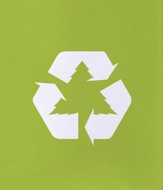 a green recycle sign with white arrows in the center