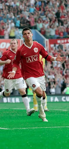 two soccer players are running on the field