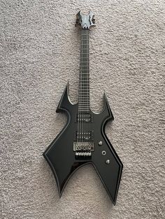 an electric guitar laying on the ground with it's neck cut out to show its unique shape