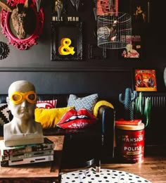 a living room filled with furniture and pictures on the wall next to a busturine