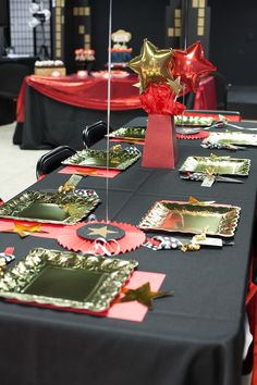 a table topped with lots of red and gold decorations