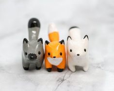 three small toy animals sitting next to each other