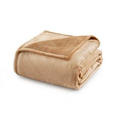 a tan blanket folded on top of each other