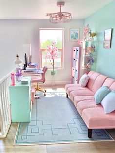 a living room with pink couches and blue rugs on the floor in front of a window