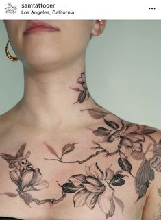 a woman with tattoos on her chest and neck