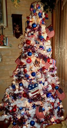 a decorated christmas tree with red, white and blue decorations