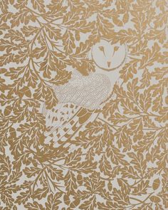 an intricately designed wallpaper with white and gold leaves on it, featuring a bird in the center