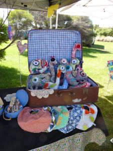 an open suitcase sitting on top of a table filled with baby items in it's trunk