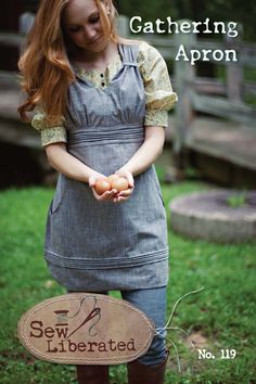 a girl holding an egg in her hands and standing next to a sign that says gathering apron