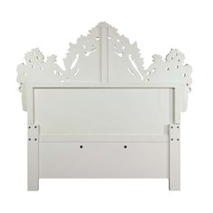 a white headboard with an intricate design on the top and bottom part of it