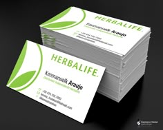 two business cards stacked on top of each other with the words herblife printed on them