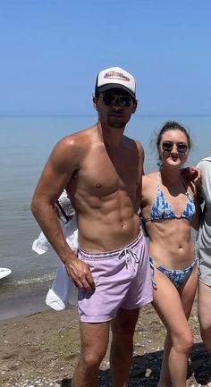 a man and two women standing on the beach