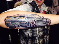 a man with a car tattoo on his arm