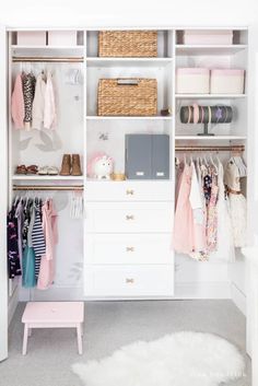 a white closet filled with lots of baby clothes