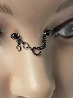 the nose is chained with chains and balls on it's side, as well as eyes