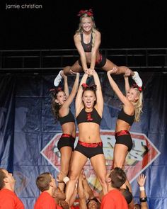 the cheerleaders are doing tricks on the stage