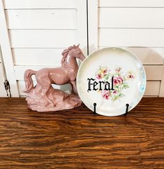 there is a plate with the word fera on it next to a toy horse