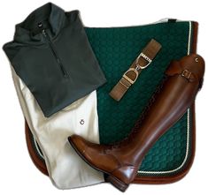 a pair of brown boots sitting on top of a green rug next to a black shirt and white pants