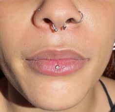 a woman with piercings on her nose