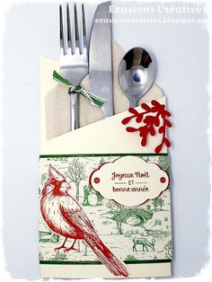 a fork, spoon and card with a bird on it