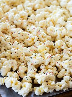 popcorn with sprinkles is on a baking sheet