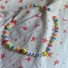 a bracelet with smiley face beads and happy words