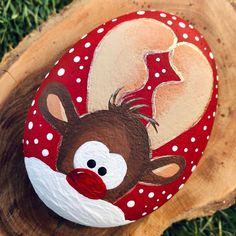 a painted rock with a reindeer on it