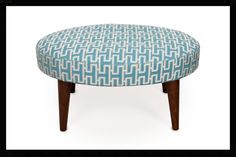 an upholstered foot stool with wooden legs in blue and white geometric print fabric