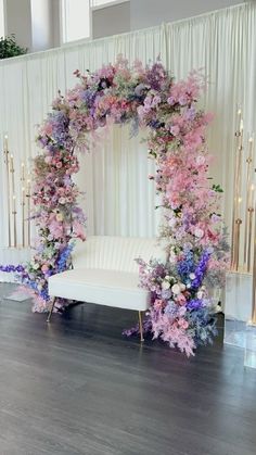 a white couch sitting under a floral arch