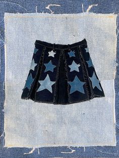 -made to order- 100% deep-navy denim with a hand-sewn/treated denim star design, perfect for the diva that knows 'these are my legs and they're ready for prime-time'. each 'box pleat' is framed with a distressed navy-blue patchwork and three distressed stars. this garment is built to fray and get even better after multiple wears. zipper in back with waistband snap. length: '14-'15 see FAQ for size chart all pieces sewn by me made-to-order items ship within 1-2 weeks. Denim Stars, The Diva, Get Even, Prime Time, Star Design, Box Pleats, Star Designs, Star Shape, Pleated Skirt